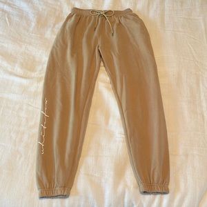 white fox sand sweatpants, size M, cursive(white fox) at bottom of leg